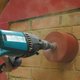 A 152mm Dry Diamond Core Drill being used to drill a hole in a wall.